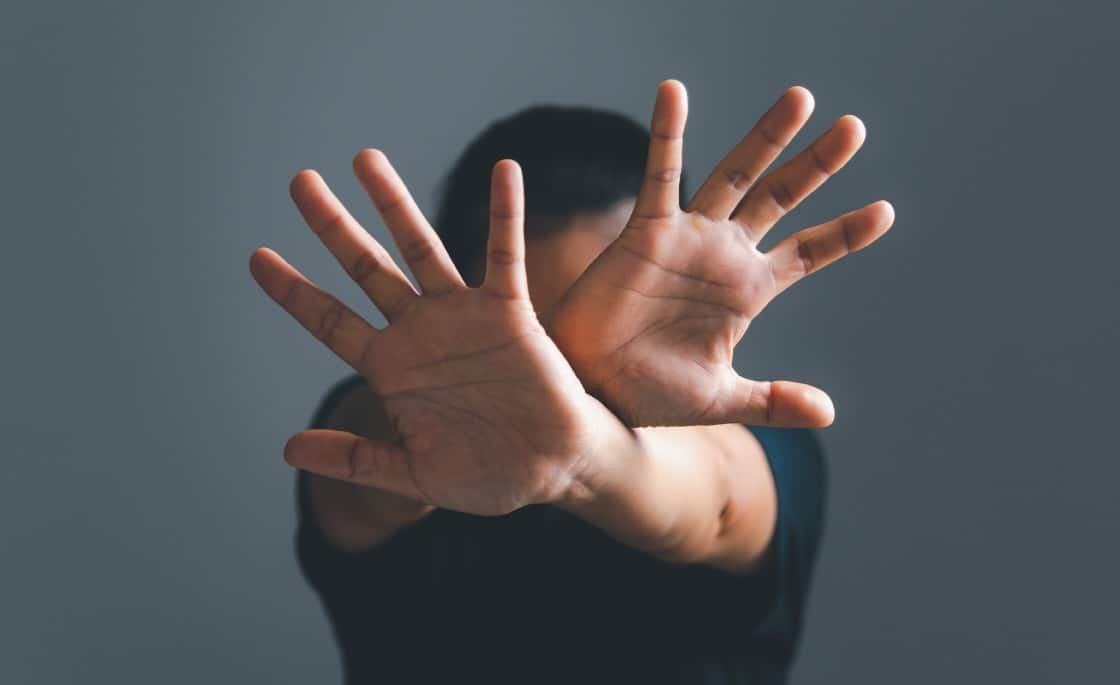 manos cruzadas diciendo no a la violencia